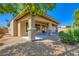 Backyard featuring a covered patio with stone pillars, gravel landscaping and mature bushes at 3908 Specula Wing Dr, North Las Vegas, NV 89084