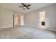 Bedroom with neutral carpet, ceiling fan, and view to the ensuite bathroom at 3908 Specula Wing Dr, North Las Vegas, NV 89084