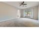 Spacious bedroom with carpet flooring, ceiling fan, and large window providing natural light at 3908 Specula Wing Dr, North Las Vegas, NV 89084