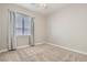 Bedroom featuring soft carpet, a ceiling fan, and a window allowing natural light to stream in at 3908 Specula Wing Dr, North Las Vegas, NV 89084
