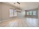 Bright dining room featuring tile flooring, modern chandelier, neutral paint, and ample natural light from the windows at 3908 Specula Wing Dr, North Las Vegas, NV 89084