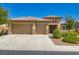 Beautiful single-story home featuring a three-car garage, desert landscaping, and a charming entryway at 3908 Specula Wing Dr, North Las Vegas, NV 89084