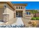 Inviting home entrance featuring stone accents, desert landscaping, and a well-lit walkway at 3908 Specula Wing Dr, North Las Vegas, NV 89084
