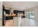 Modern kitchen featuring stainless steel appliances, dark cabinets, and granite countertops at 3908 Specula Wing Dr, North Las Vegas, NV 89084