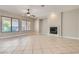 Bright living room with a cozy fireplace, large windows, and tile flooring at 3908 Specula Wing Dr, North Las Vegas, NV 89084