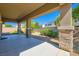 Covered patio area with stone columns, offering an inviting outdoor space for relaxation and entertaining at 3908 Specula Wing Dr, North Las Vegas, NV 89084