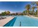 Beautiful swimming pool features chairs, tables, and umbrellas at 3908 Specula Wing Dr, North Las Vegas, NV 89084