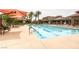Resort-style pool with a covered patio and seating, perfect for relaxing and enjoying the outdoors at 3908 Specula Wing Dr, North Las Vegas, NV 89084