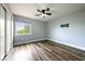 Bright bedroom features wood floors, a ceiling fan, and mount for TV at 6045 Riverwalk Falls St # 102, North Las Vegas, NV 89031