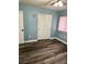 Bedroom featuring stylish flooring, blue walls, closet, and fan at 6045 Riverwalk Falls St # 102, North Las Vegas, NV 89031