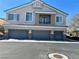 Inviting home featuring a three-car garage and a charming second-story balcony at 6045 Riverwalk Falls St # 102, North Las Vegas, NV 89031
