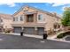 Three car garage exterior showcasing contemporary design and well-maintained landscaping at 6045 Riverwalk Falls St # 102, North Las Vegas, NV 89031