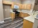 Traditional kitchen features wooden cabinets, stainless steel appliances, and tile backsplash at 6045 Riverwalk Falls St # 102, North Las Vegas, NV 89031