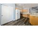 Bright kitchen featuring wood cabinets, white appliances, and hardwood floors at 6045 Riverwalk Falls St # 102, North Las Vegas, NV 89031
