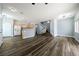 Open-concept living space with hardwood floors seamlessly connects to the kitchen area at 6045 Riverwalk Falls St # 102, North Las Vegas, NV 89031