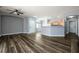 Spacious living room with hardwood floors, ceiling fan, and abundant natural light at 6045 Riverwalk Falls St # 102, North Las Vegas, NV 89031