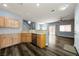 Well-lit living area with modern appliances, a kitchen bar, and sleek, continuous flooring at 6045 Riverwalk Falls St # 102, North Las Vegas, NV 89031