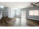 Bright living room features hardwood floors, a ceiling fan, and sliding glass doors at 6045 Riverwalk Falls St # 102, North Las Vegas, NV 89031