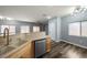 Open-concept living space with modern flooring, kitchen bar, and plenty of natural light at 6045 Riverwalk Falls St # 102, North Las Vegas, NV 89031