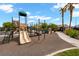 A large community playground offering multiple slides and play structures under sunny skies at 6045 Riverwalk Falls St # 102, North Las Vegas, NV 89031