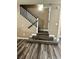 Inviting staircase featuring modern wood-look flooring and a classic white railing at 6045 Riverwalk Falls St # 102, North Las Vegas, NV 89031