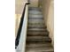 Stairway with wood-look steps and black handrail at 6045 Riverwalk Falls St # 102, North Las Vegas, NV 89031