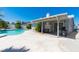 Covered patio and BBQ area overlooking a spacious pool, ideal for outdoor gatherings and relaxation at 6361 W Viking Rd, Las Vegas, NV 89103