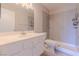 Bright bathroom with a shower and modern vanity with bright lighting and plank flooring at 6361 W Viking Rd, Las Vegas, NV 89103