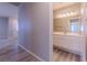 Inviting bathroom featuring white cabinets, a large mirror, and neutral walls at 6361 W Viking Rd, Las Vegas, NV 89103