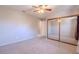 Bedroom features carpeted floors, a ceiling fan, and a mirrored closet at 6361 W Viking Rd, Las Vegas, NV 89103
