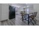 Open concept dining area featuring laminate floors with an adjacent open kitchen at 6361 W Viking Rd, Las Vegas, NV 89103