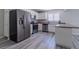 Full kitchen with stainless steel fridge, white cabinets, and ample counter space for cooking and entertaining at 6361 W Viking Rd, Las Vegas, NV 89103