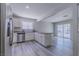 Spacious kitchen with stainless steel appliances, laminate flooring, and natural light from a nearby window at 6361 W Viking Rd, Las Vegas, NV 89103