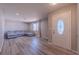 Bright and spacious living room showcasing modern flooring, a large window, and comfortable seating at 6361 W Viking Rd, Las Vegas, NV 89103