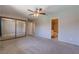 Spacious primary bedroom features a ceiling fan, carpeted floor, and a mirrored closet at 6361 W Viking Rd, Las Vegas, NV 89103