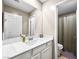 Bathroom with a single sink vanity, white cabinets, and a full mirror reflecting the shower and toilet at 8701 Giant Causeway Ave, Las Vegas, NV 89148