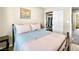 Bedroom featuring a bed, side table, a closet, and a window bringing in natural light at 8701 Giant Causeway Ave, Las Vegas, NV 89148