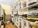 Walk-in closet with custom shelving for storage and organization with wood flooring at 8701 Giant Causeway Ave, Las Vegas, NV 89148