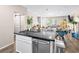 Bright kitchen offers an island with stainless steel dishwasher and sink, seamlessly connecting to the living spaces at 8701 Giant Causeway Ave, Las Vegas, NV 89148