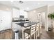 Bright kitchen boasts stainless steel appliances, an island with seating and black countertops at 8701 Giant Causeway Ave, Las Vegas, NV 89148
