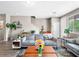 Comfortable living room featuring a plush sofa, plants and natural light at 8701 Giant Causeway Ave, Las Vegas, NV 89148