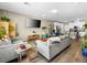 Open-concept living room with modern furnishings, a large TV, and wood-look floors at 8701 Giant Causeway Ave, Las Vegas, NV 89148