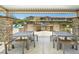Community outdoor kitchen area featuring picnic tables and a built-in grill at 8701 Giant Causeway Ave, Las Vegas, NV 89148
