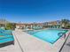 Community pool and lounge area with various lounge chairs and tables for residents to relax at 8701 Giant Causeway Ave, Las Vegas, NV 89148