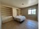 Bedroom features a pull down Murphy bed, built in book shelves, and a window for natural light at 9048 Litchfield Ave, Las Vegas, NV 89134