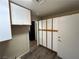 Hallway with wooden floors and built in shelving against the wall at 9048 Litchfield Ave, Las Vegas, NV 89134