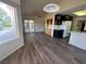 Living room open to the kitchen featuring tile flooring, overhead lighting, and patio access at 9048 Litchfield Ave, Las Vegas, NV 89134