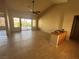 Open living room with tile floors, a ceiling fan, and sliding doors to the outdoor patio at 9048 Litchfield Ave, Las Vegas, NV 89134
