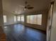 Open concept living room with tile flooring, modern ceiling fan, and multiple windows at 9048 Litchfield Ave, Las Vegas, NV 89134