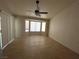 Spacious living room featuring tile flooring, large bay window and access to the backyard at 9048 Litchfield Ave, Las Vegas, NV 89134